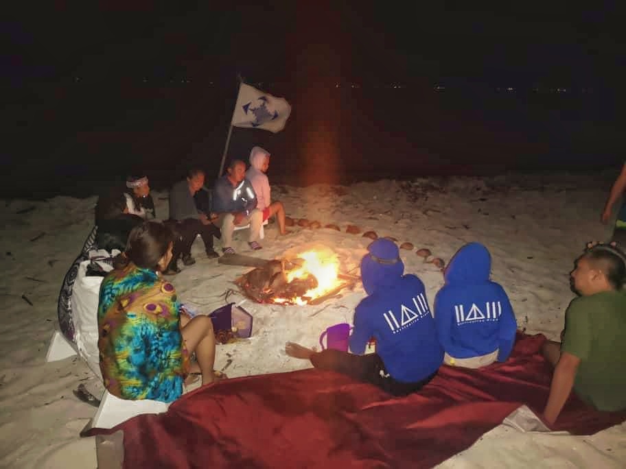 Campfires burning by the beach with good company.